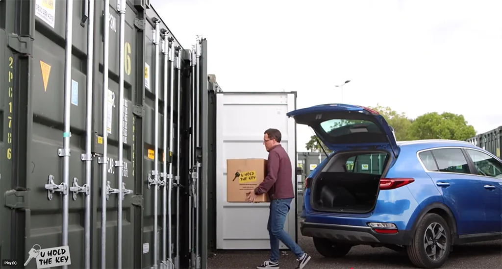 Man loading packaging box into storage container